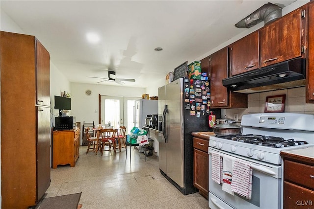 kitchen featuring white range with gas cooktop, french doors, decorative backsplash, stainless steel fridge, and ceiling fan