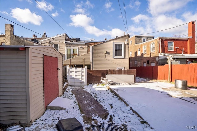 snow covered property featuring a storage unit