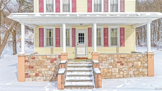 view of snow covered property entrance