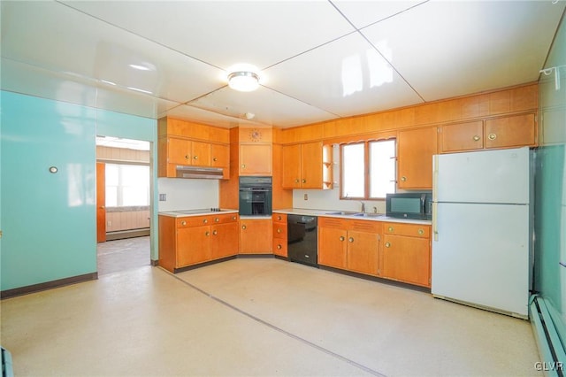 kitchen featuring black appliances, a wealth of natural light, a baseboard radiator, and sink