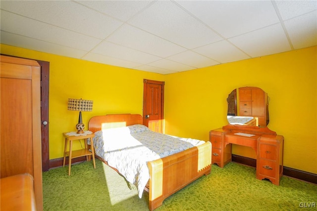 bedroom featuring a paneled ceiling and carpet