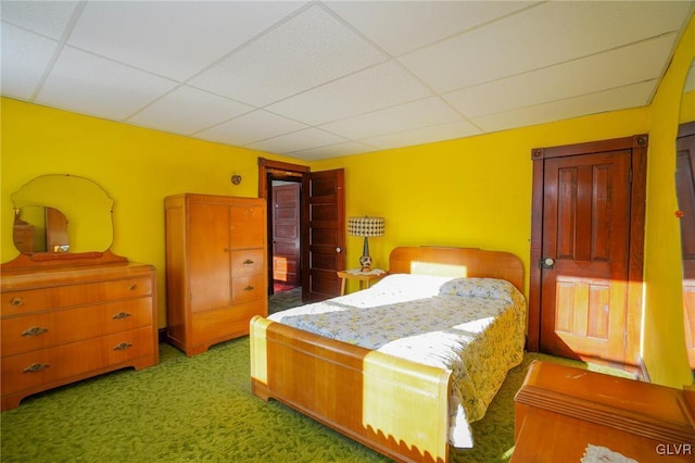 carpeted bedroom with a drop ceiling