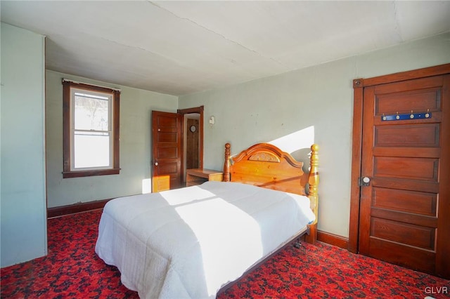 bedroom featuring dark colored carpet