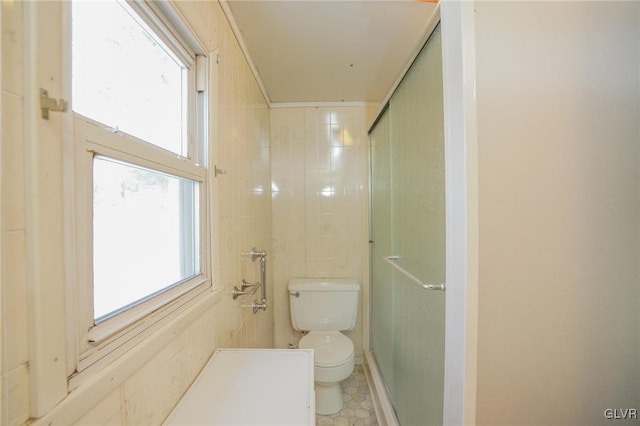 bathroom with an enclosed shower and toilet