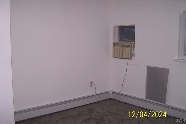 carpeted empty room with cooling unit and a baseboard heating unit