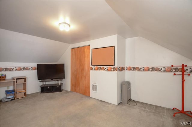 additional living space featuring lofted ceiling and light carpet