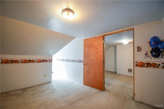 bonus room featuring light colored carpet and lofted ceiling