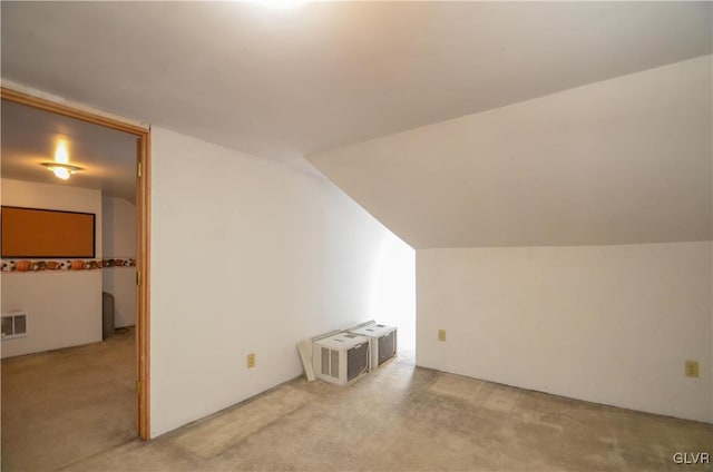 additional living space featuring carpet flooring and vaulted ceiling