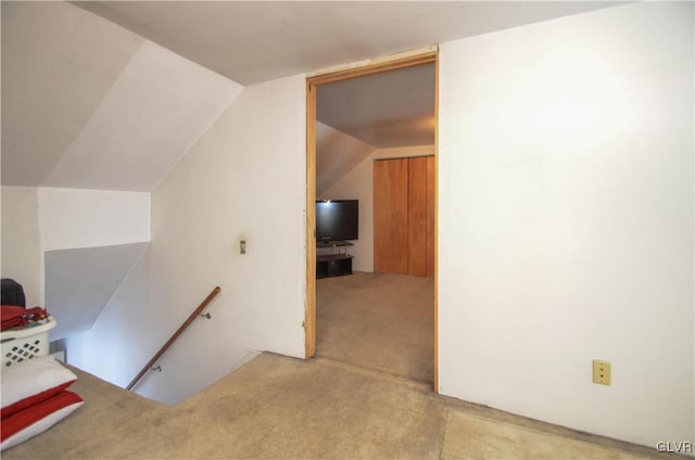 interior space featuring carpet and lofted ceiling