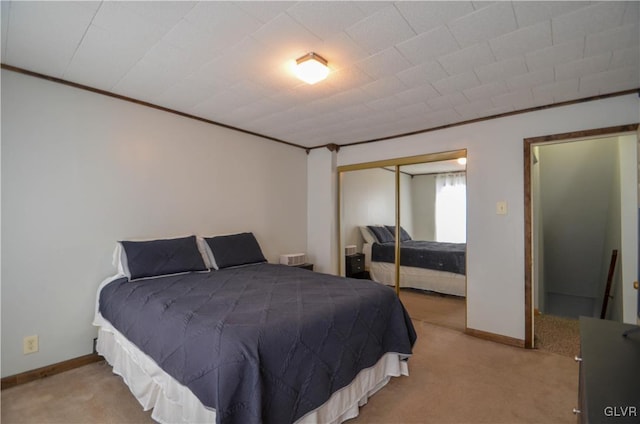 carpeted bedroom featuring a closet and ornamental molding