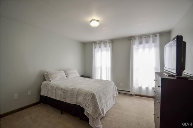 bedroom featuring baseboard heating and light carpet