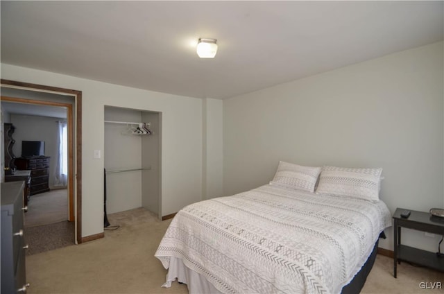 bedroom featuring light colored carpet and a closet