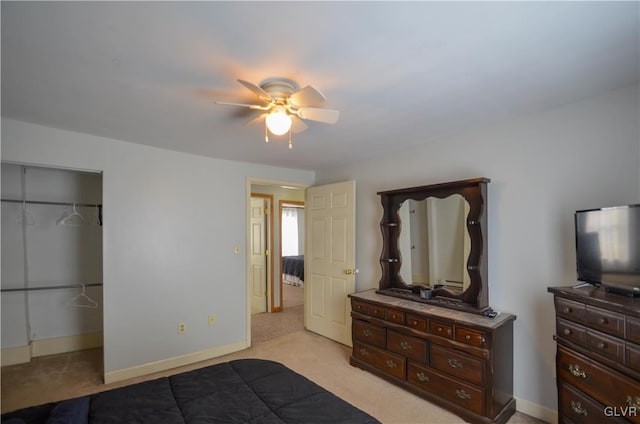 bedroom featuring light colored carpet, a closet, and ceiling fan