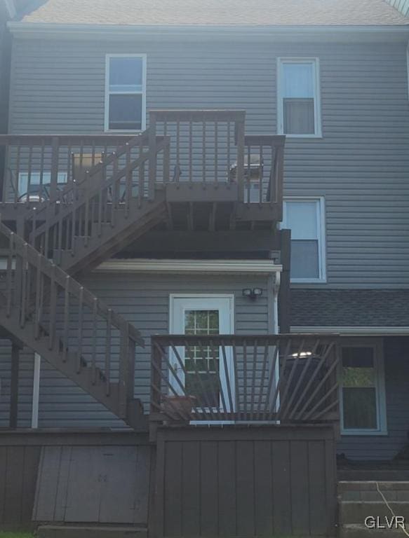 rear view of property featuring a deck