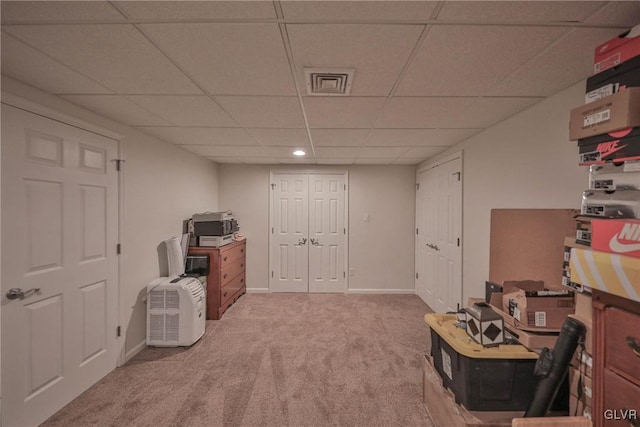 misc room featuring a drop ceiling and carpet