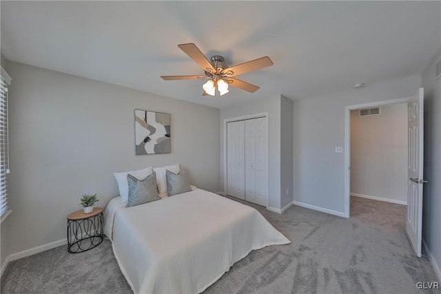 carpeted bedroom with a closet and ceiling fan