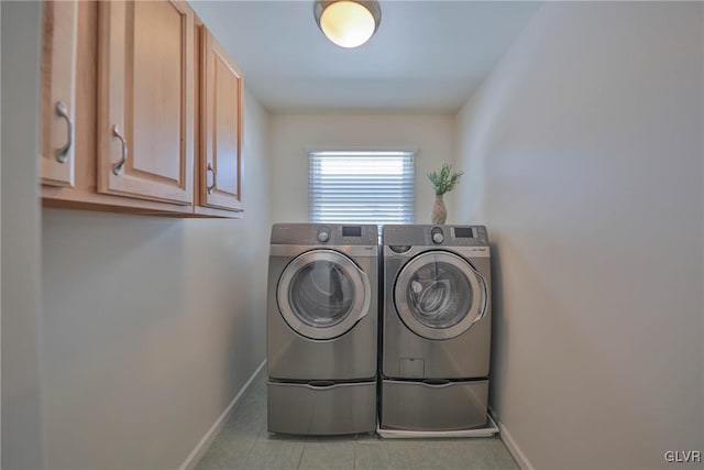 clothes washing area with cabinets and independent washer and dryer