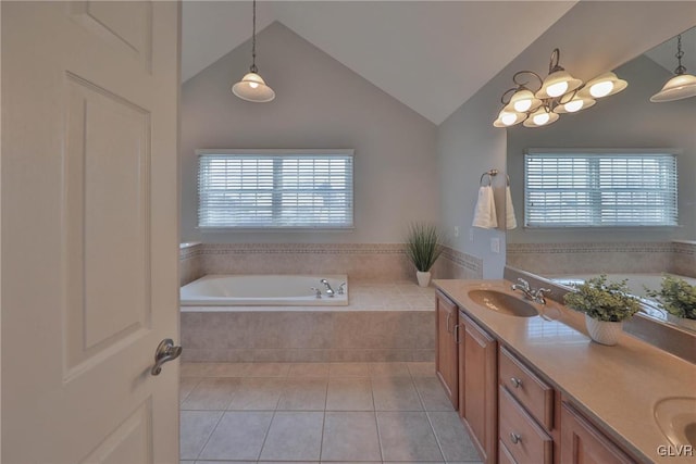 bathroom featuring tiled bath, tile patterned flooring, vanity, and a healthy amount of sunlight