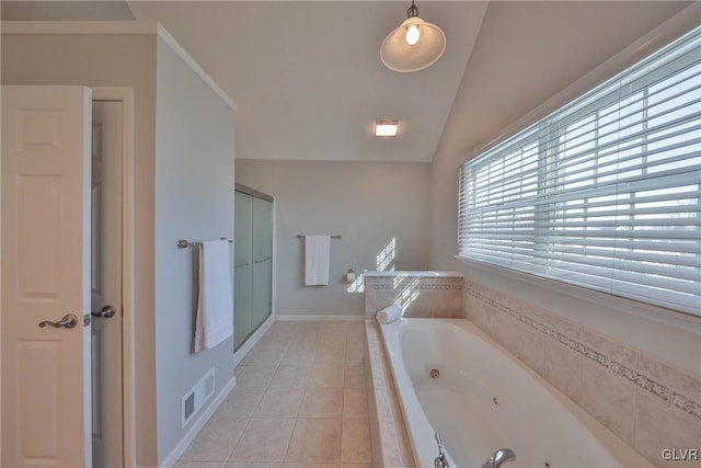 bathroom with independent shower and bath, vaulted ceiling, and tile patterned floors