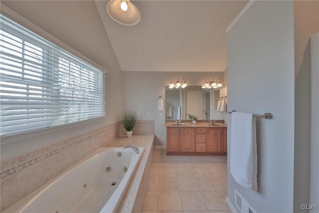 bathroom featuring a relaxing tiled tub, vanity, lofted ceiling, and tile patterned flooring