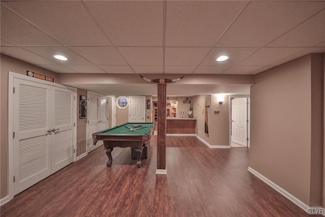 recreation room featuring pool table, a drop ceiling, and dark hardwood / wood-style flooring