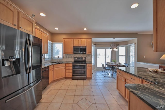 kitchen featuring pendant lighting, appliances with stainless steel finishes, sink, plenty of natural light, and light tile patterned floors