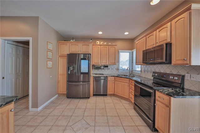 kitchen with sink, stainless steel appliances, light tile patterned floors, and light brown cabinets