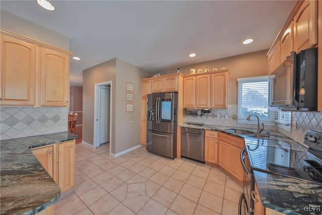 kitchen with sink, stainless steel appliances, light tile patterned floors, and backsplash