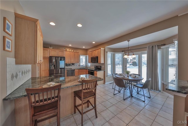 kitchen featuring dishwasher, tasteful backsplash, stainless steel fridge, black electric range oven, and kitchen peninsula