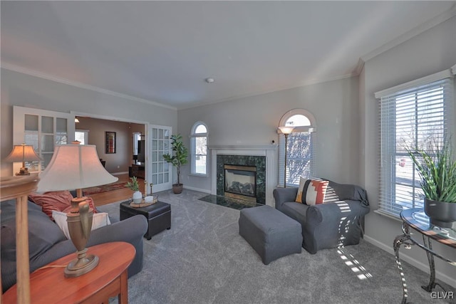 living room featuring french doors, carpet, a high end fireplace, and ornamental molding