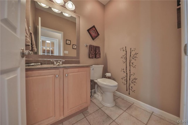 bathroom featuring vanity, toilet, and tile patterned flooring