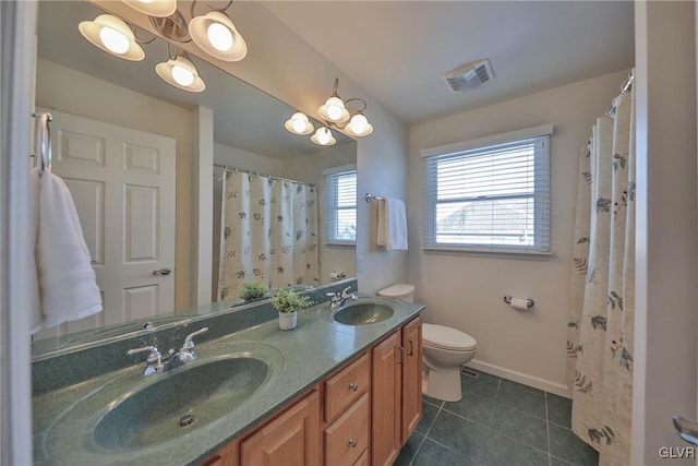 bathroom featuring toilet, tile patterned flooring, and vanity