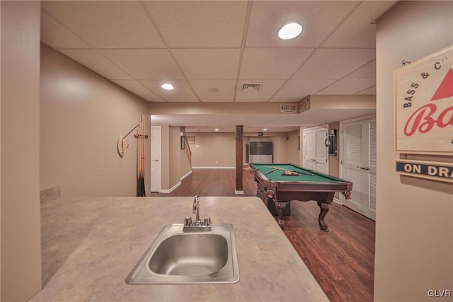 recreation room with sink, dark hardwood / wood-style floors, a paneled ceiling, and billiards