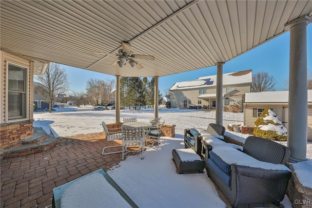 snow covered patio featuring ceiling fan