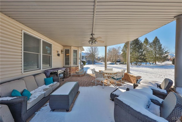 snow covered patio with ceiling fan and outdoor lounge area