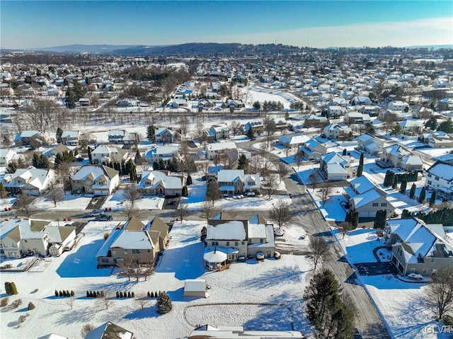 snowy aerial view featuring a mountain view