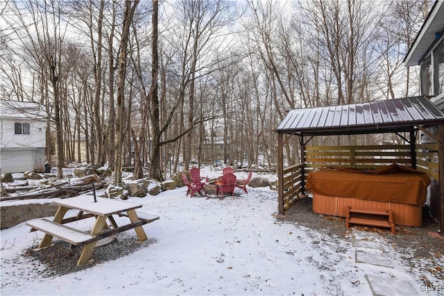 yard layered in snow with a fire pit