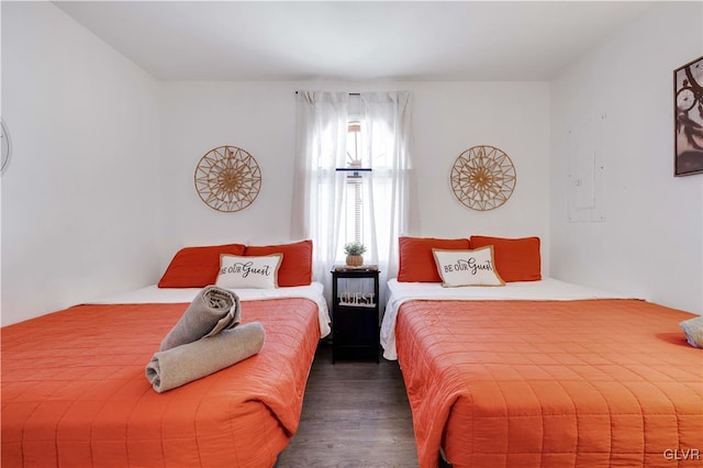 bedroom with dark wood-type flooring