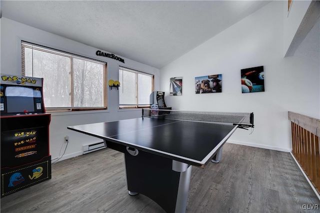 rec room with hardwood / wood-style flooring, baseboard heating, vaulted ceiling, and a textured ceiling