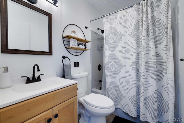 full bathroom with vanity, toilet, shower / bath combo, and a textured ceiling