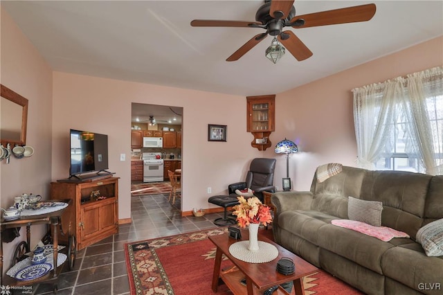 tiled living room with ceiling fan