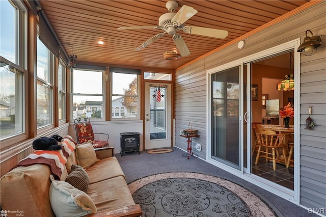 sunroom / solarium featuring ceiling fan and wooden ceiling