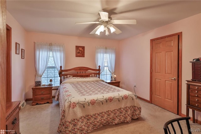 carpeted bedroom with ceiling fan and multiple windows