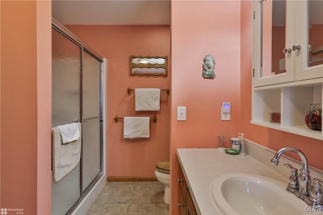 bathroom featuring vanity, toilet, and walk in shower