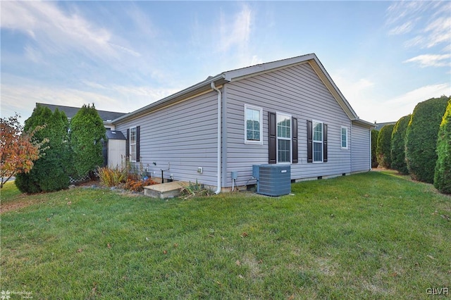 view of property exterior featuring a lawn and central AC