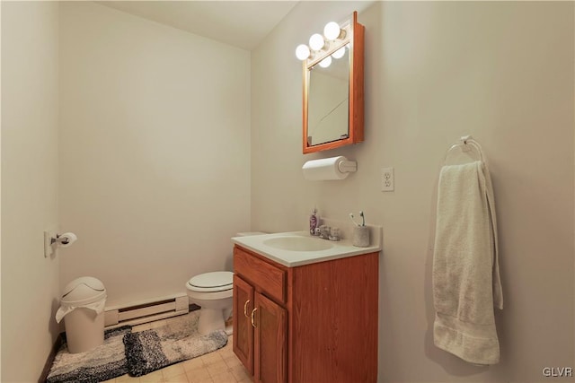 bathroom featuring a baseboard radiator, toilet, and vanity