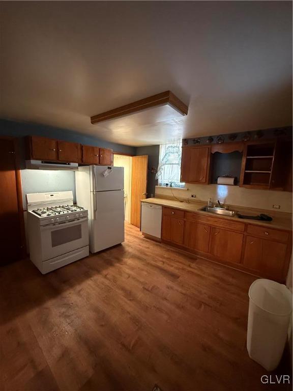 kitchen with sink, hardwood / wood-style floors, and white appliances