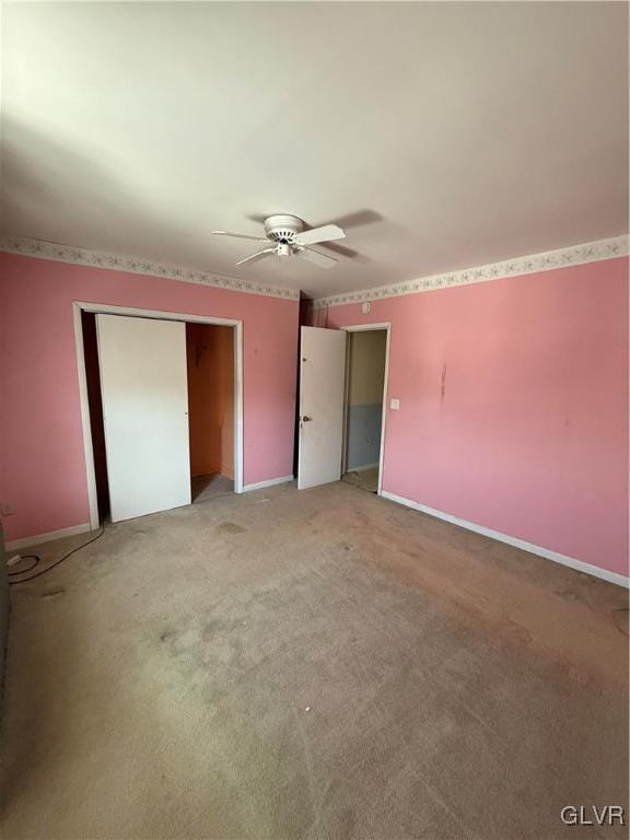 unfurnished bedroom with a closet, ceiling fan, and carpet