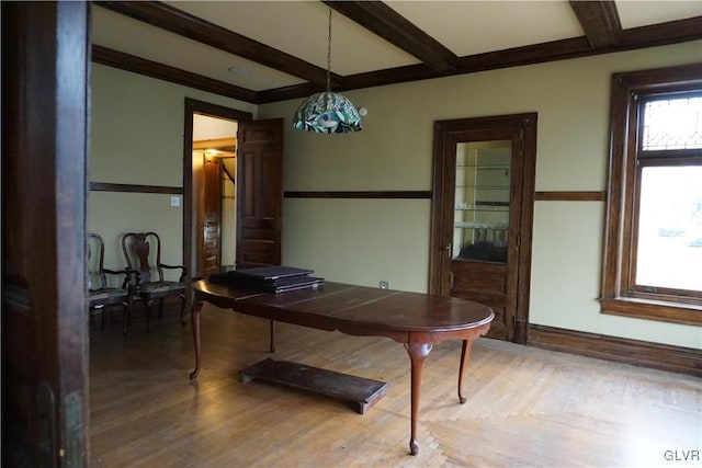 dining room with beamed ceiling and light hardwood / wood-style floors