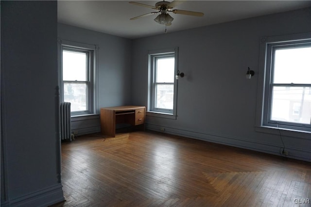 unfurnished room with radiator and a wealth of natural light